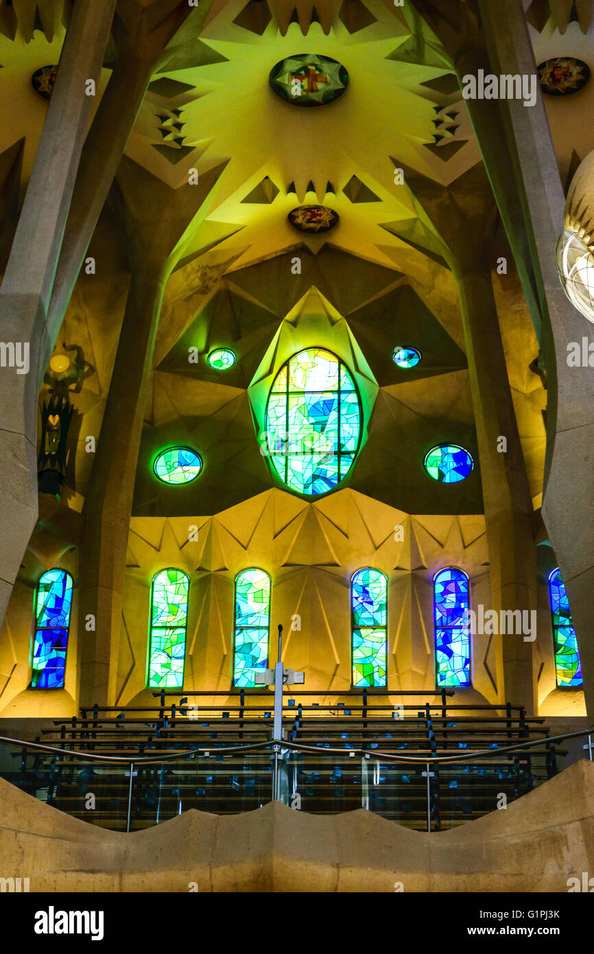 Iconic stained glass windows and choir seats inside La Sagrada Família