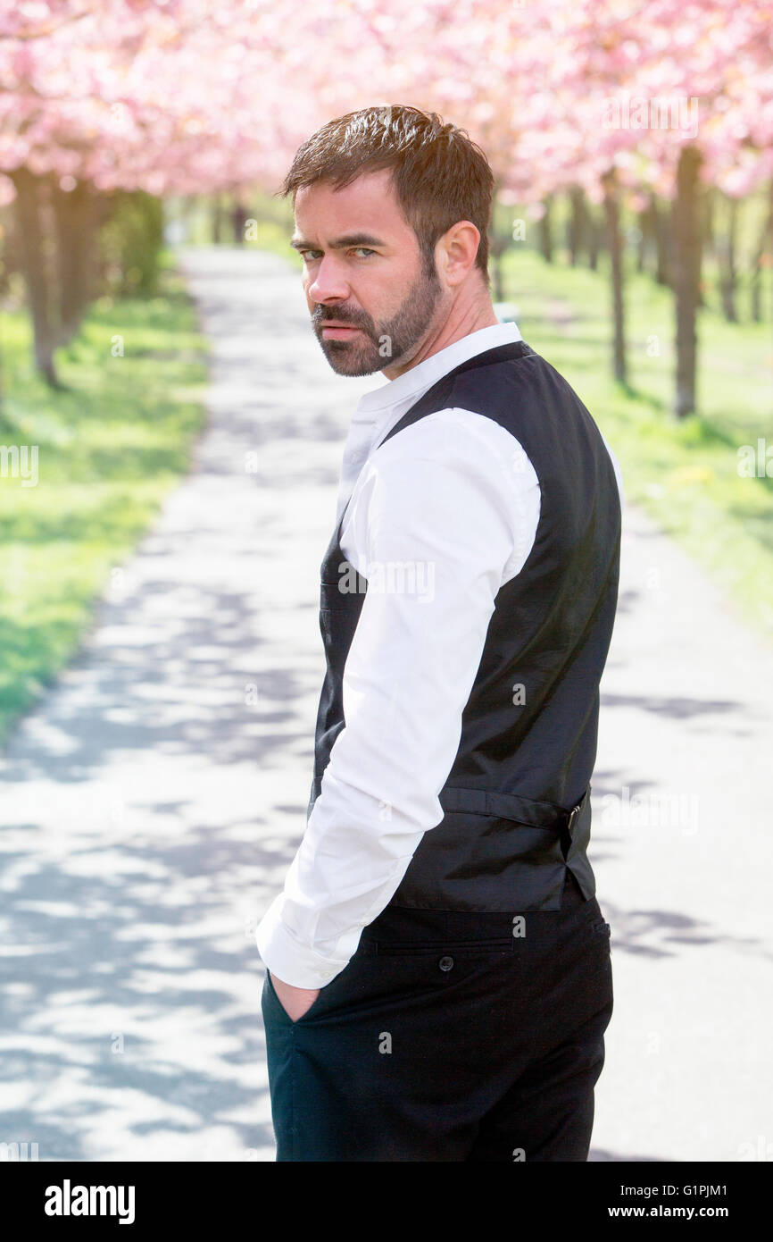 portrait of handsome man in front of cherry blossom Stock Photo - Alamy