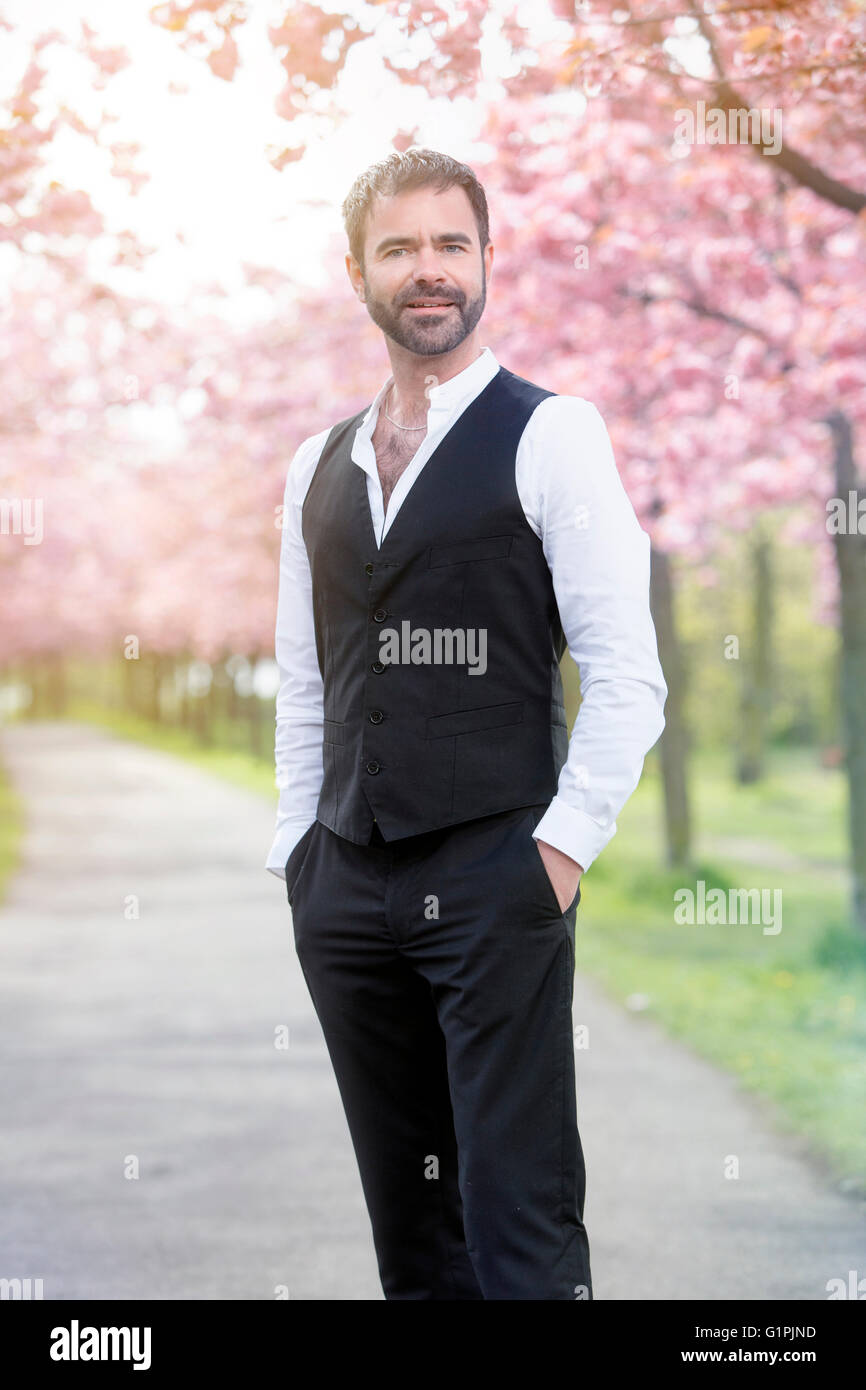 portrait of handsome man in front of cherry blossom Stock Photo - Alamy