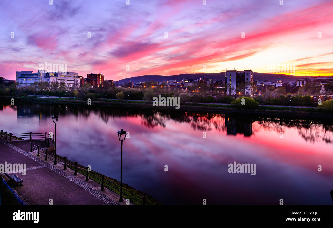 Purple tinged sunset over Belfast City Centre and the River Lagan Stock Photo