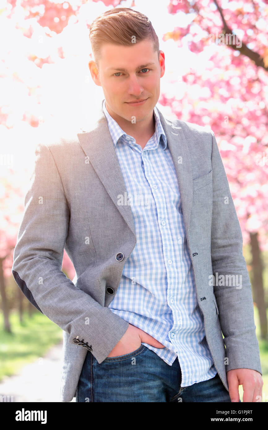 portrait of handsome man in front of cherry blossom Stock Photo - Alamy