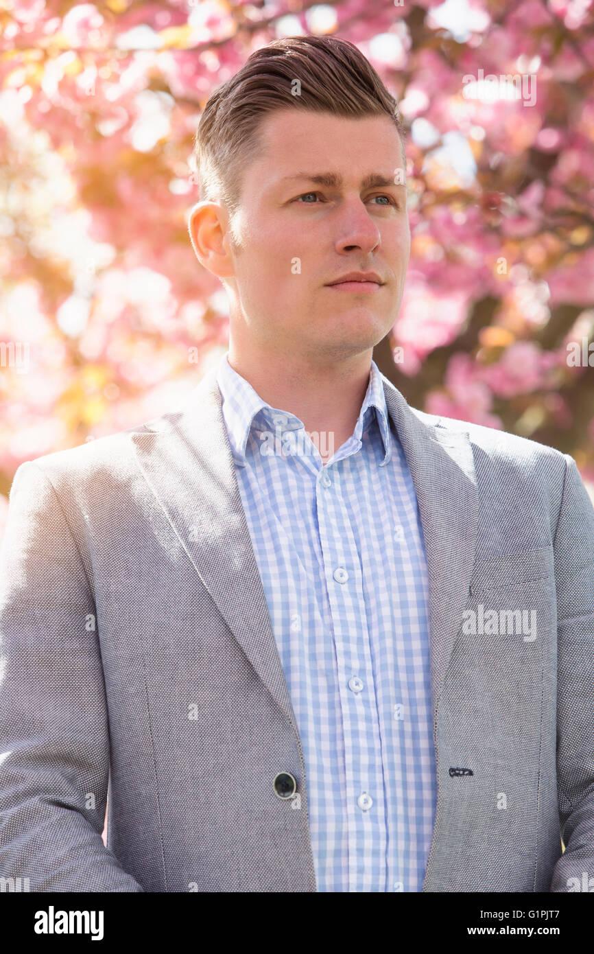 portrait of handsome man in front of cherry blossom Stock Photo - Alamy