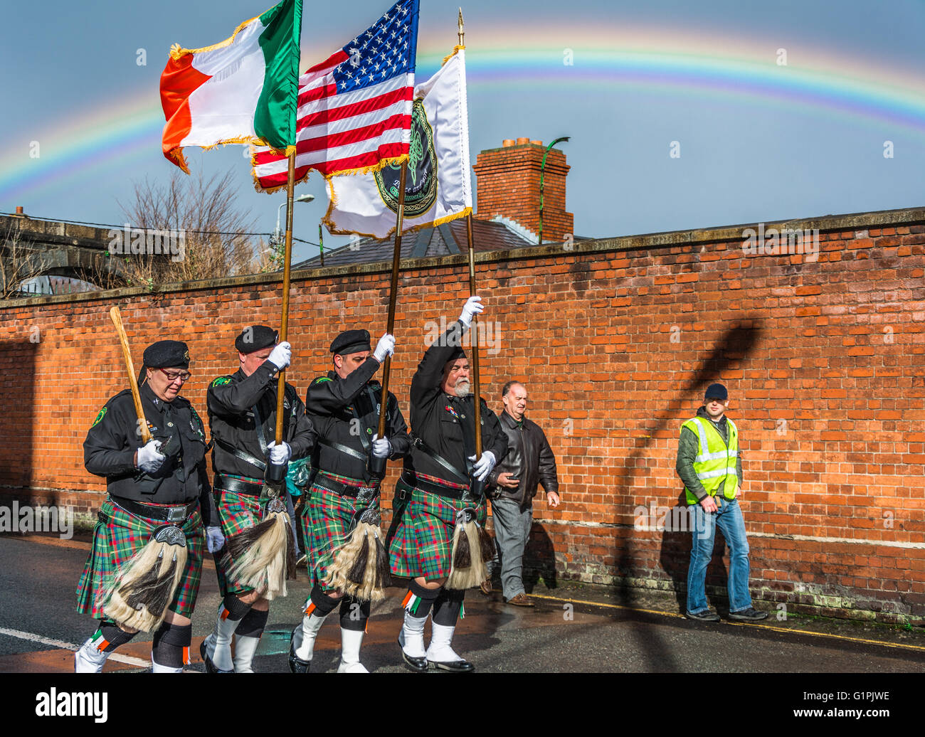 Irish American band marching through Arbour Hill in Dublin for the Easter Rising 1916 Centenary events carrying flags. Stock Photo