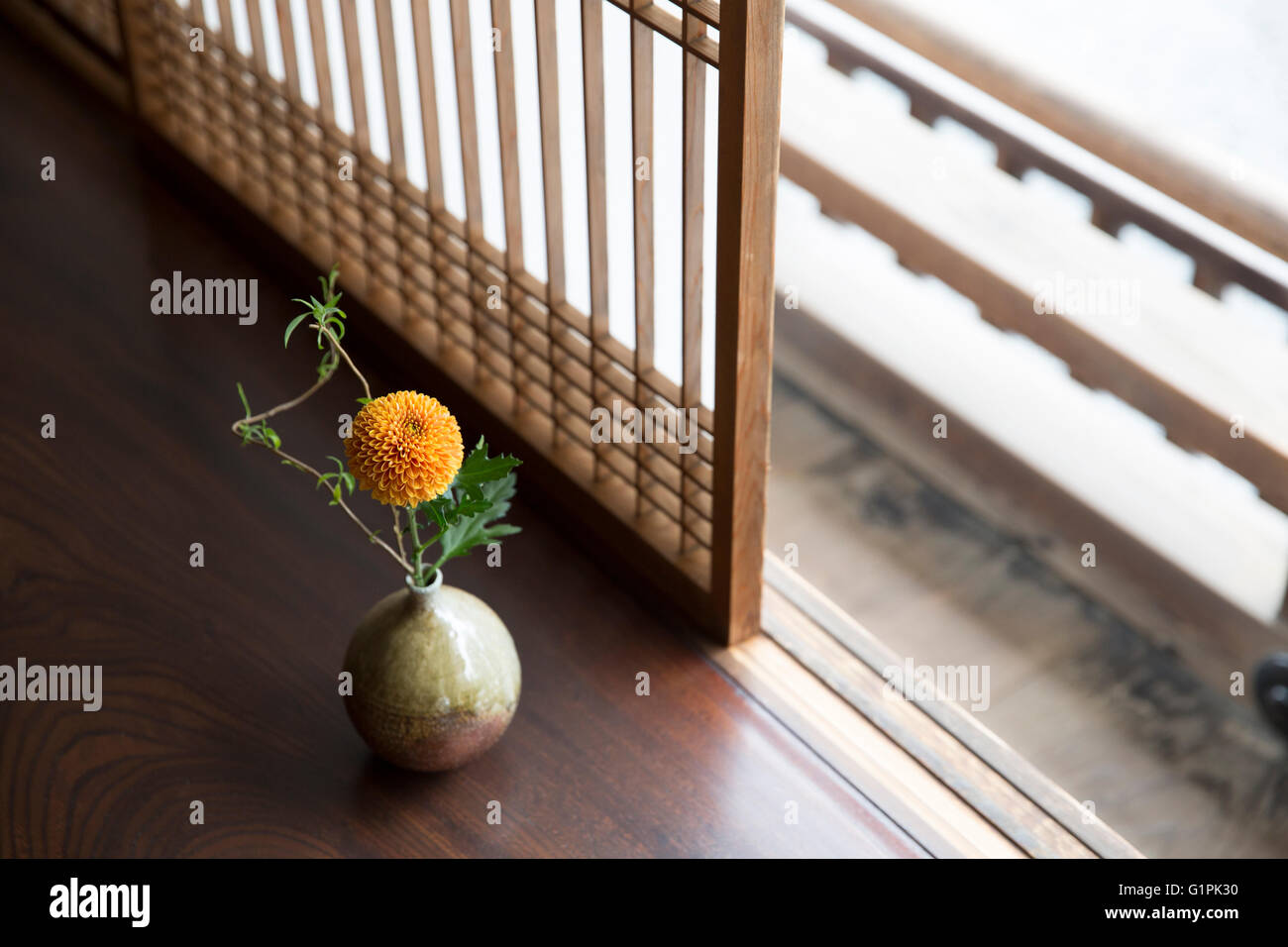 Flower in vase on wooden porch Stock Photo