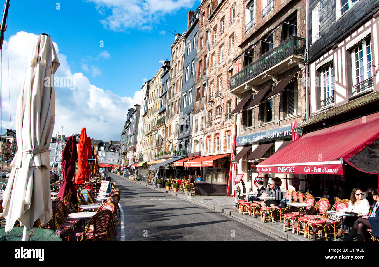 People sitting in outdoor restaurant on Quai Saint Catherine in port of