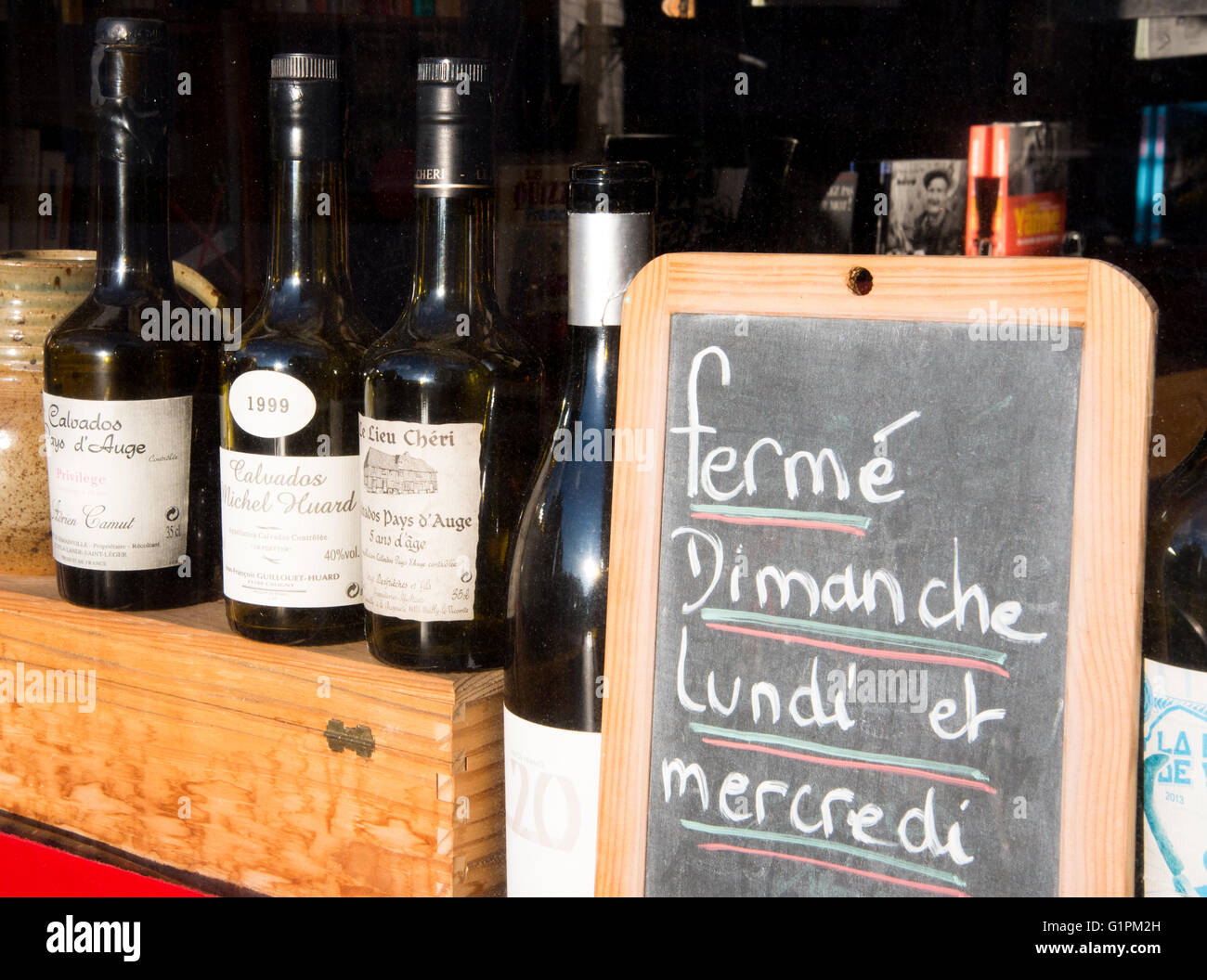 Bottles of Calvados in shop window in Honfleur, Normandy, France Stock Photo