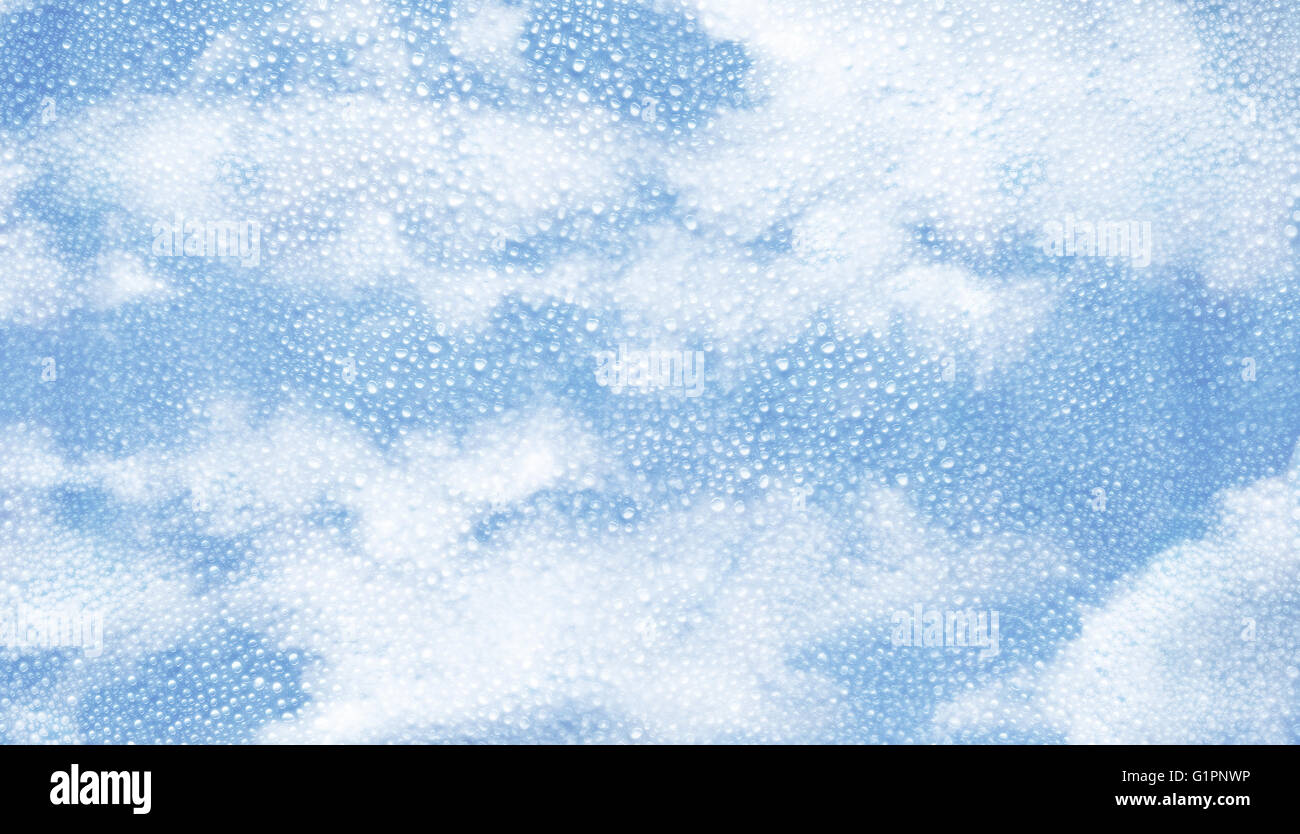 Glass with condensation of water droplets and blue sky background. Cloudy weather. horizontal composition Stock Photo