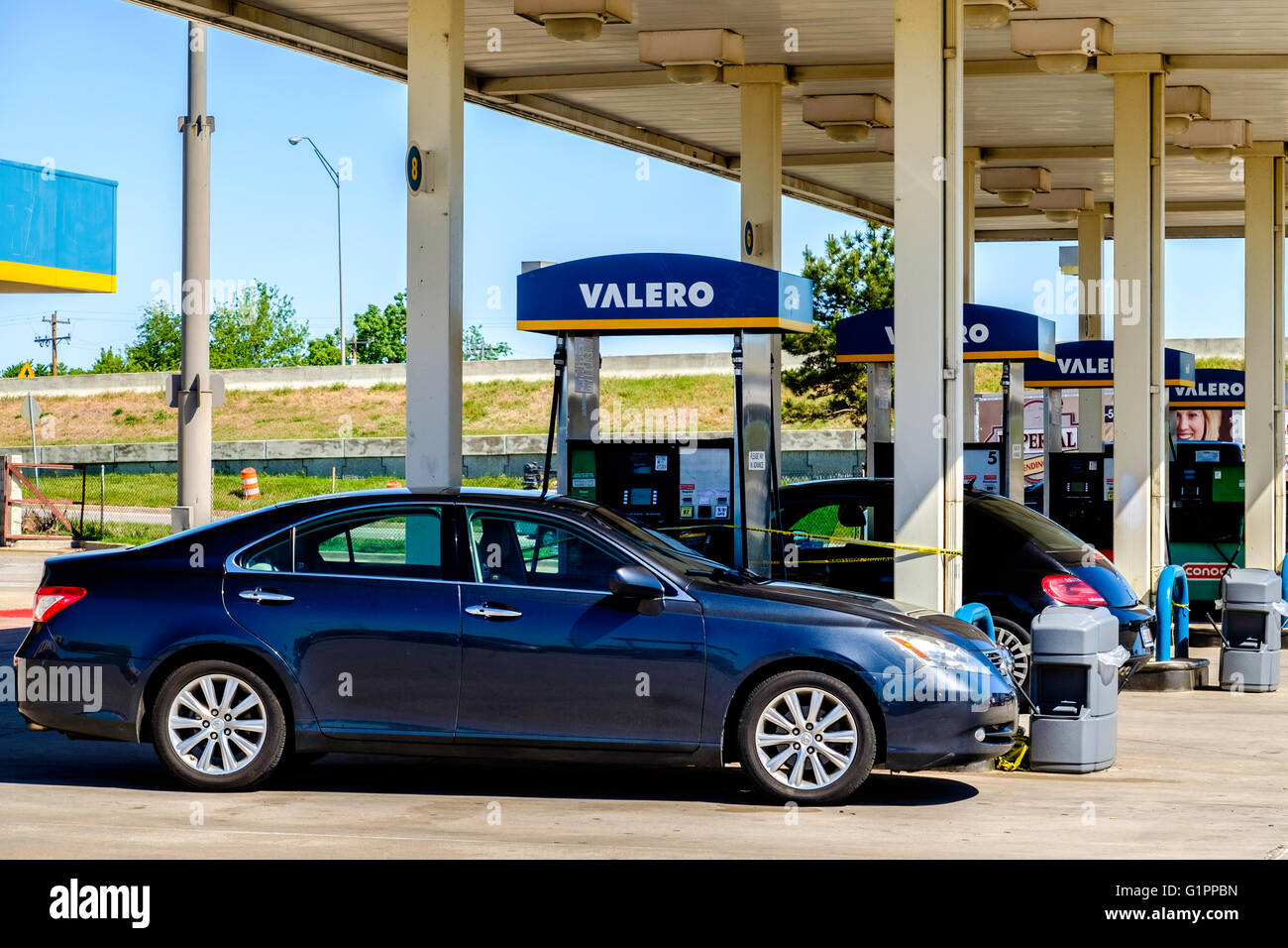 Automobiles parked next to gasoline pumps at a Valera gas station in Oklahoma City, Oklahoma, USA. Stock Photo