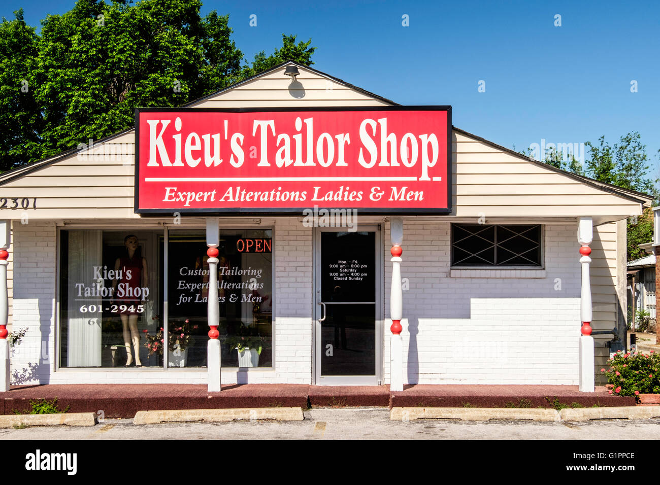 The exterior of a small tailor shop inside a remodeled former home. Stock Photo