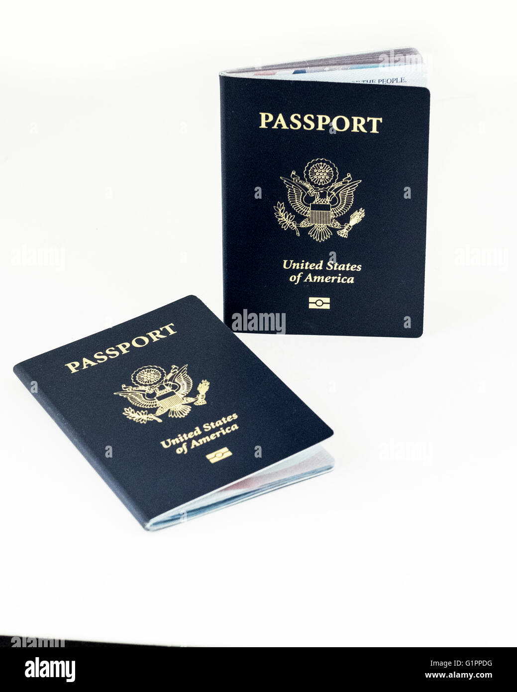 Two United States of America passport books on a white background. Stock Photo