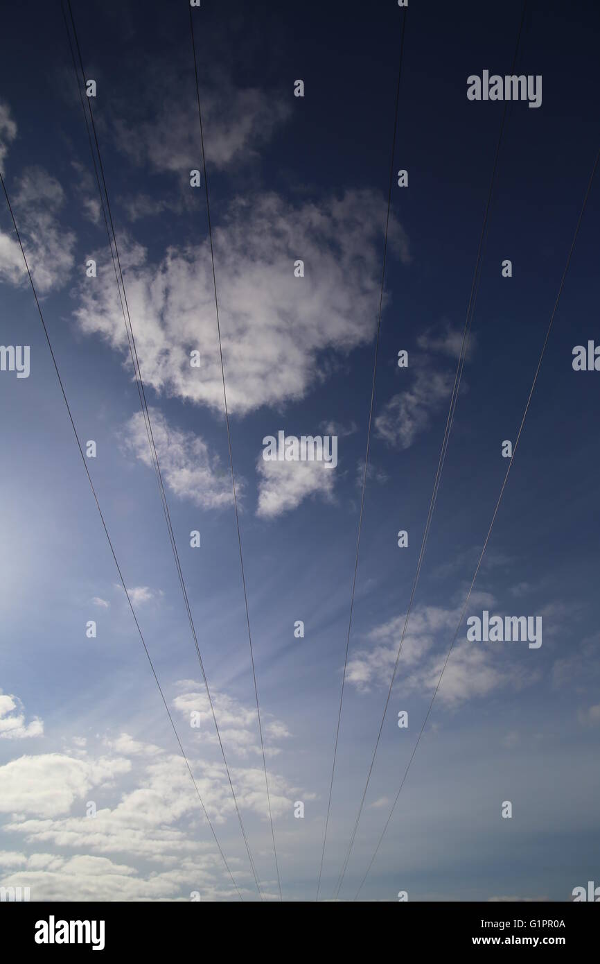 Cables on high voltage power line on a dark blue sky with cloudscape ...
