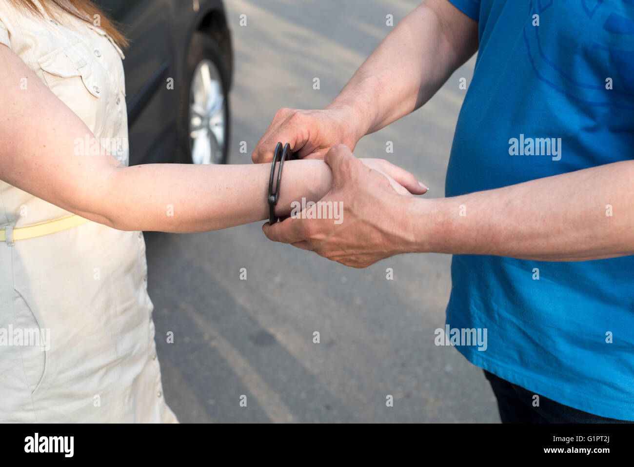 photo showing the arrest of a young woman by a police officer Stock ...