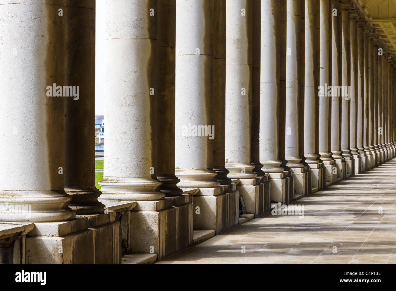 Colonnade and shadow in Old Royal Naval College, University of Greenwich, London. Stock Photo