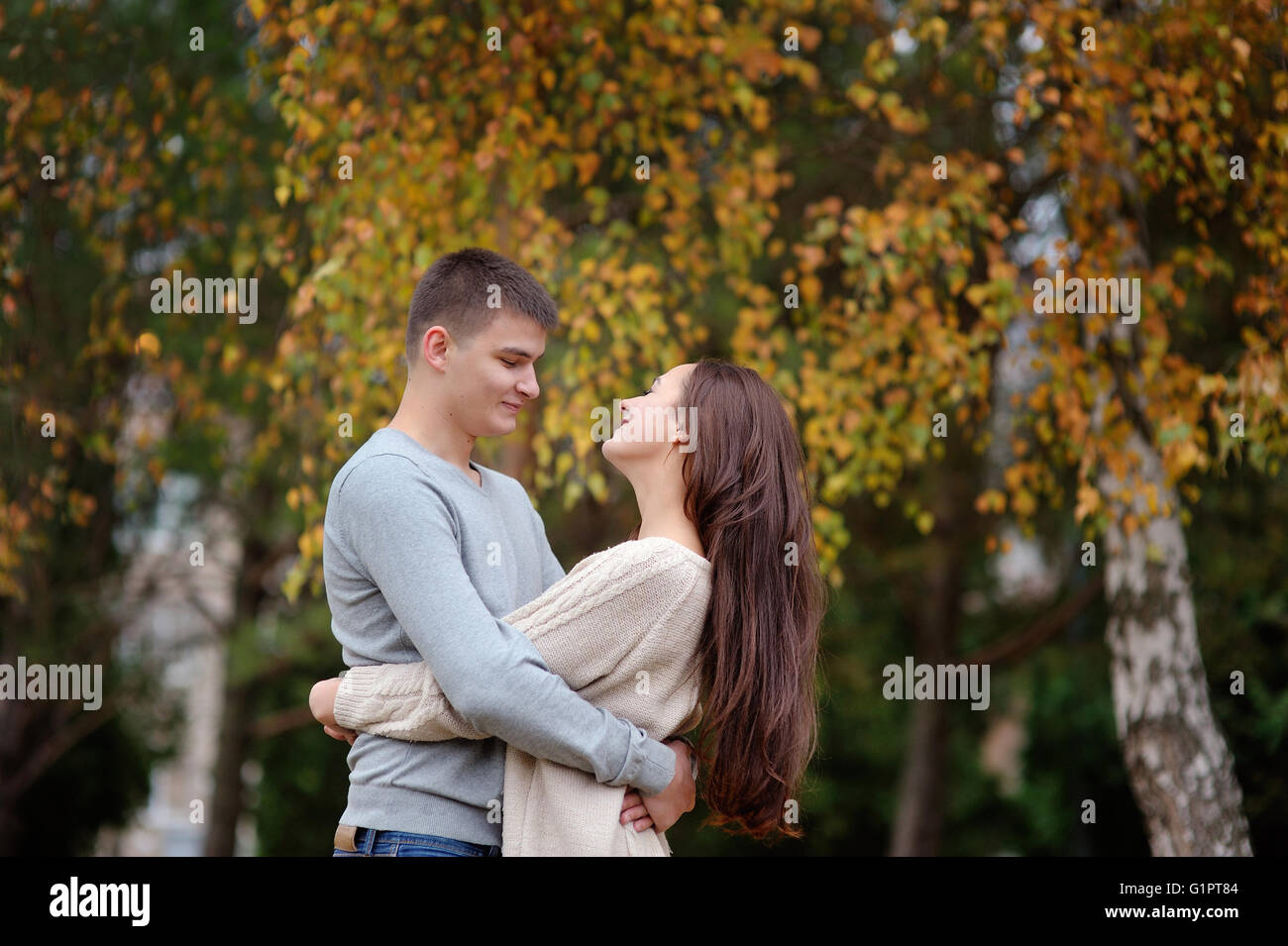 happy young couple embracing outdoor in the autumn park Stock Photo