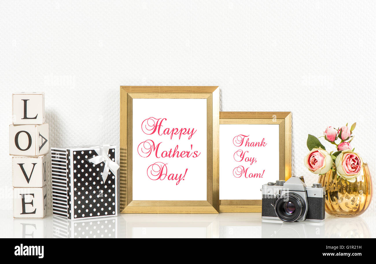 Golden picture frames, roses flowers and no name vintage camera. Copy space for Your designs. Happy Mothers Day Stock Photo