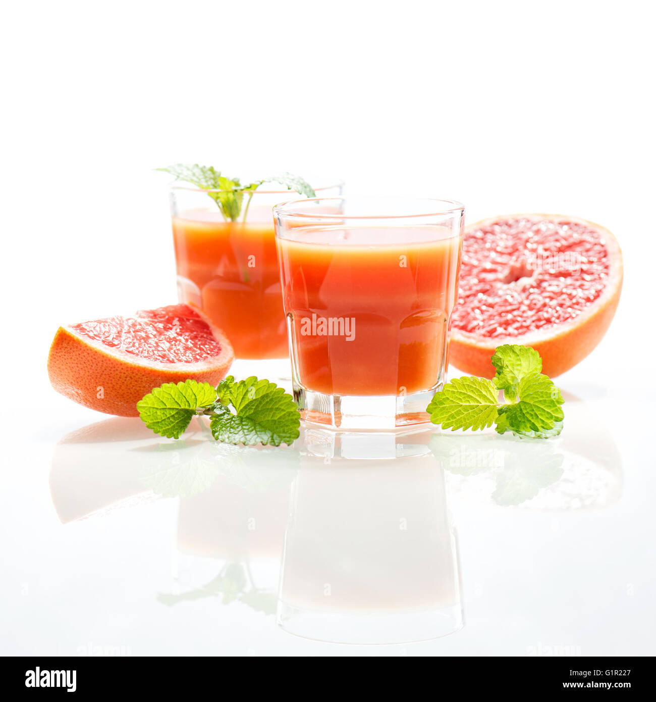 Grapefruit juice with fruits and mint leaves. High key morning light Stock Photo