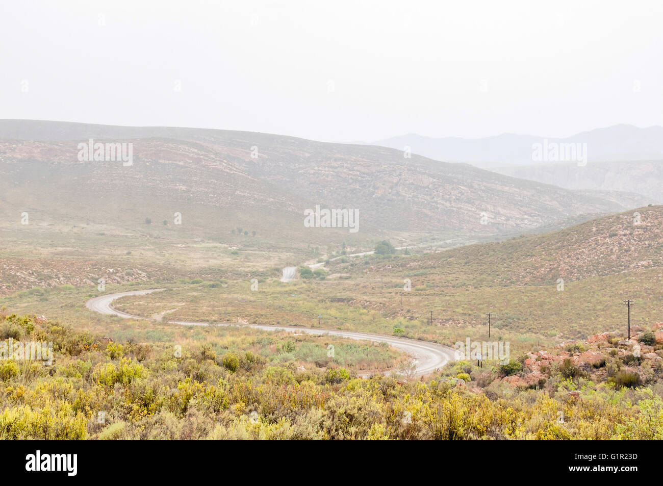 A wet Nuwekloofpas (new valley pass) descending into the Baviaanskloof (baboon valley) during a rain storm Stock Photo