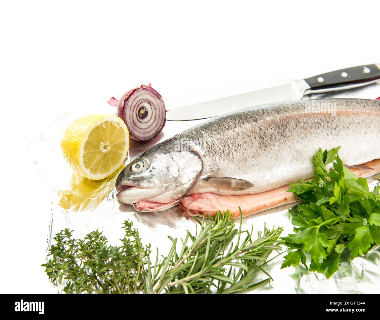 Salmon trout fish with fresh spices and herbs on white background. Healthy sea food Stock Photo