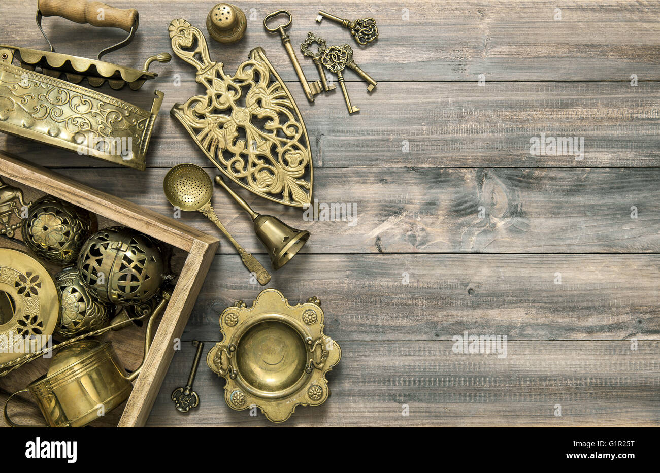 Vintage brass table ware. Kitchen table with antique tools and utensils Stock Photo