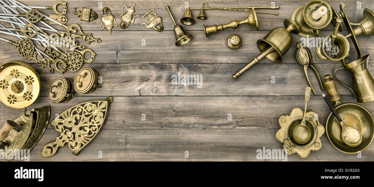 Kitchen table with antique tools and utensils. Vintage brass table ware Stock Photo