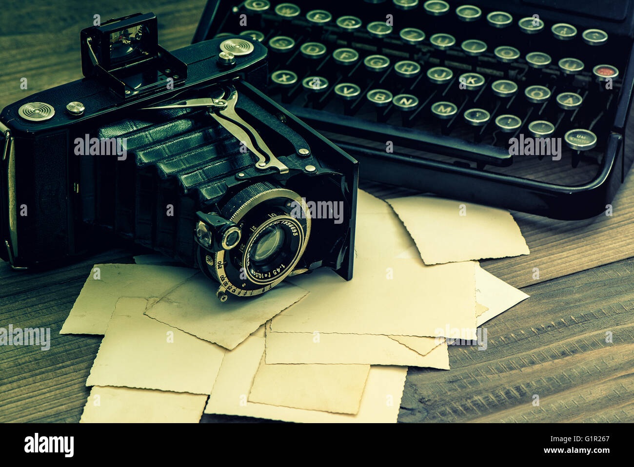 Vintage photo camera and antique typewriter. Retro style toned picture Stock Photo