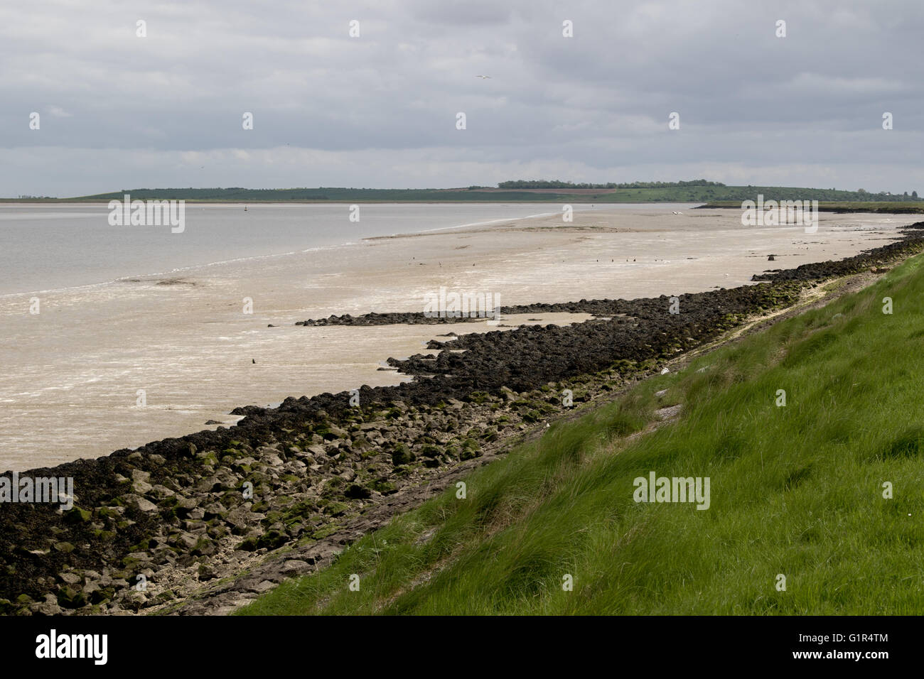 River Swale looking eastwards towards the Thames Estuary from Saxon Shore Way on an overcast day at low tide Stock Photo