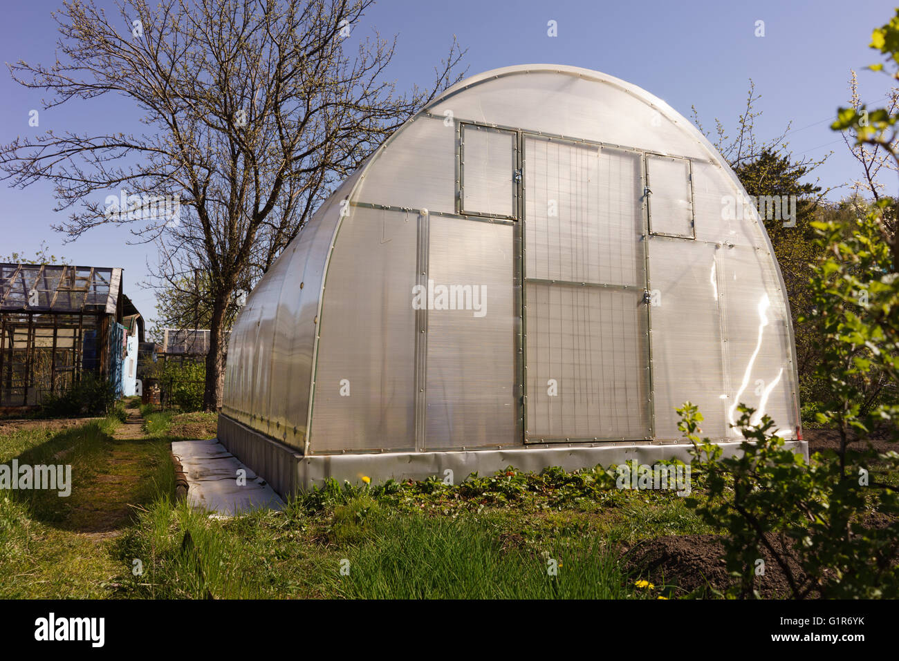 A small greenhouse with air vents in the garden Stock Photo Alamy