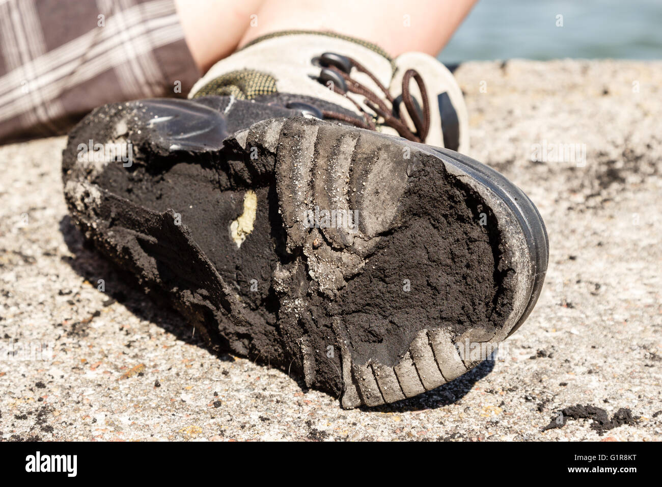 Outdoor trip holidays relax footwear concept. Checking on worn out shoe. Person with destroyed old boot. Stock Photo