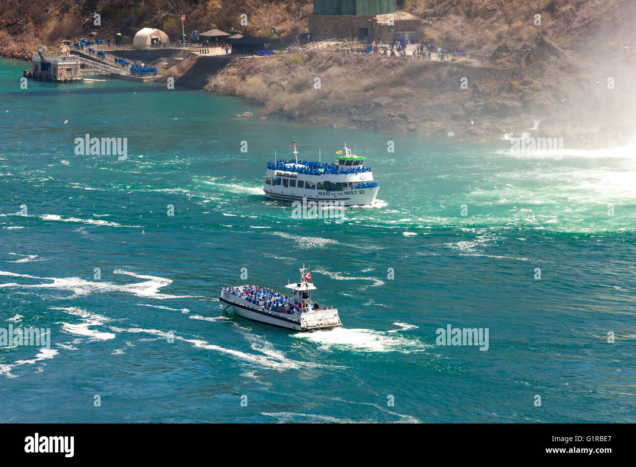 May 7, 2016 - Niagara Falls, Ont. The Maid of The Mist sails past the bottom of the American Falls. Stock Photo