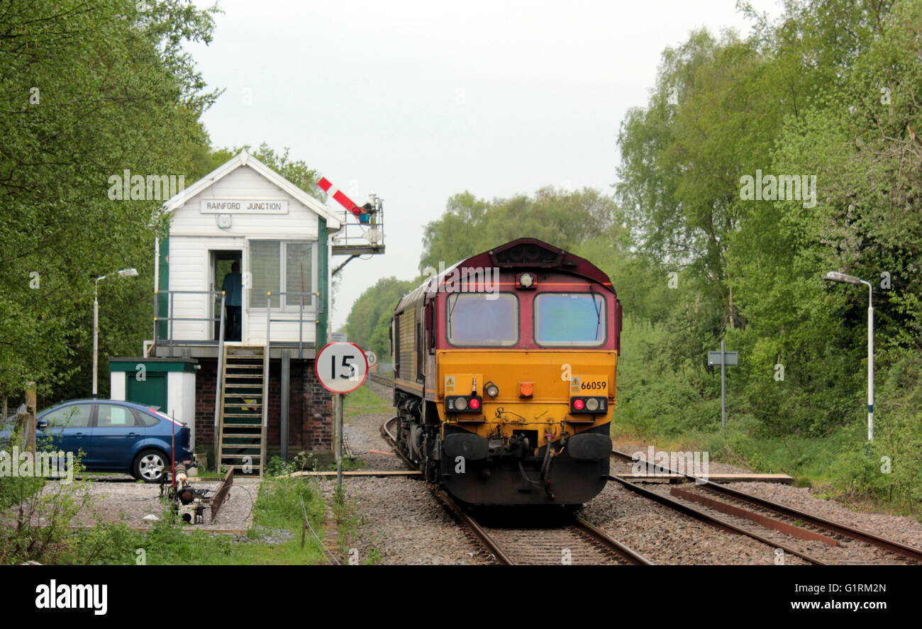 DB Cargo’s diesel locomotive departing from the signal box at Rainford Jct signal box on 10th May 2016 on the line between Wigan and Kirkby Stock Photo