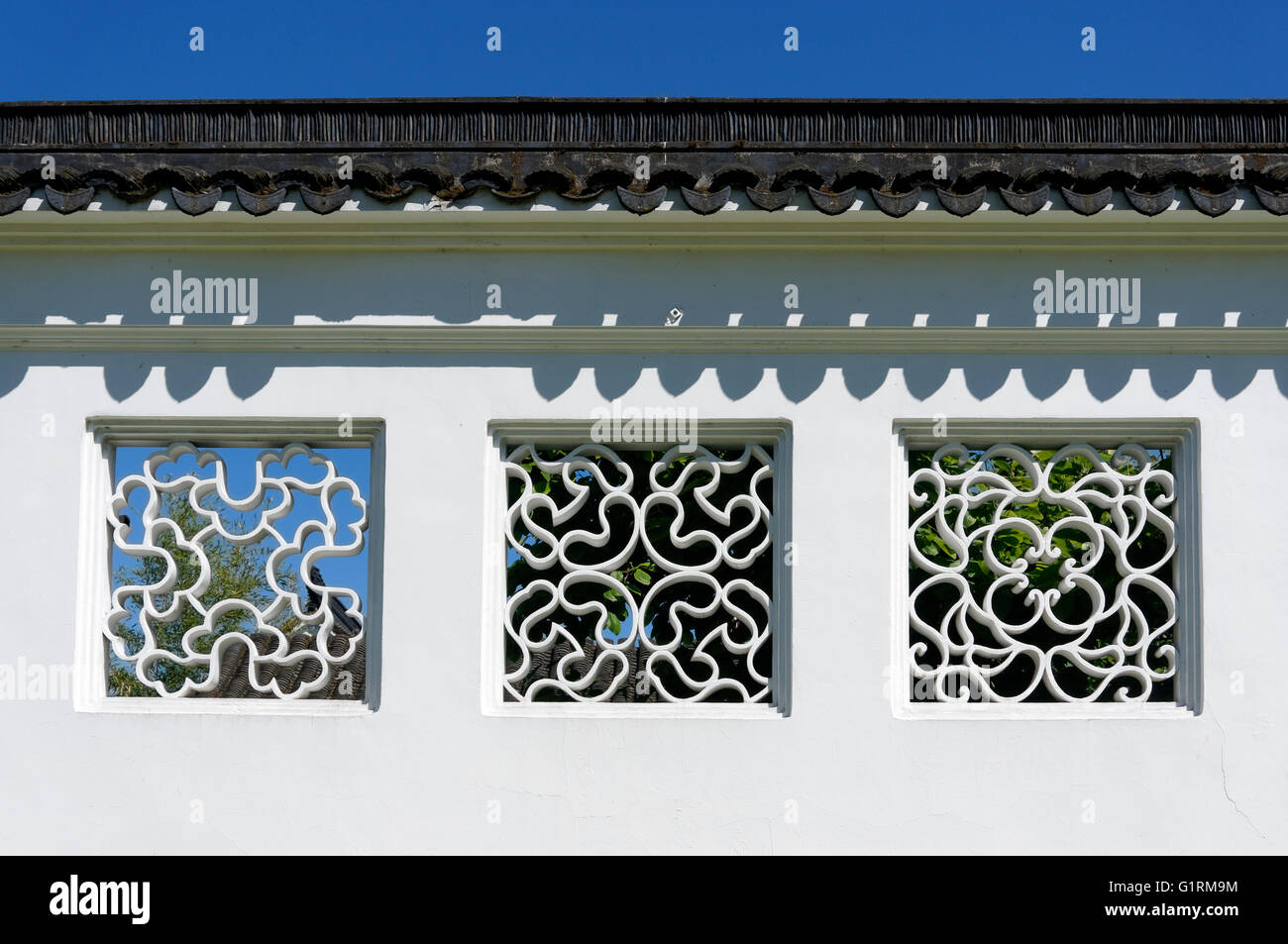 Ornate lattice window vents on the wall of the Sun Yat-Sen Classical Chinese Garden in Vancouver, BC, Canada Stock Photo