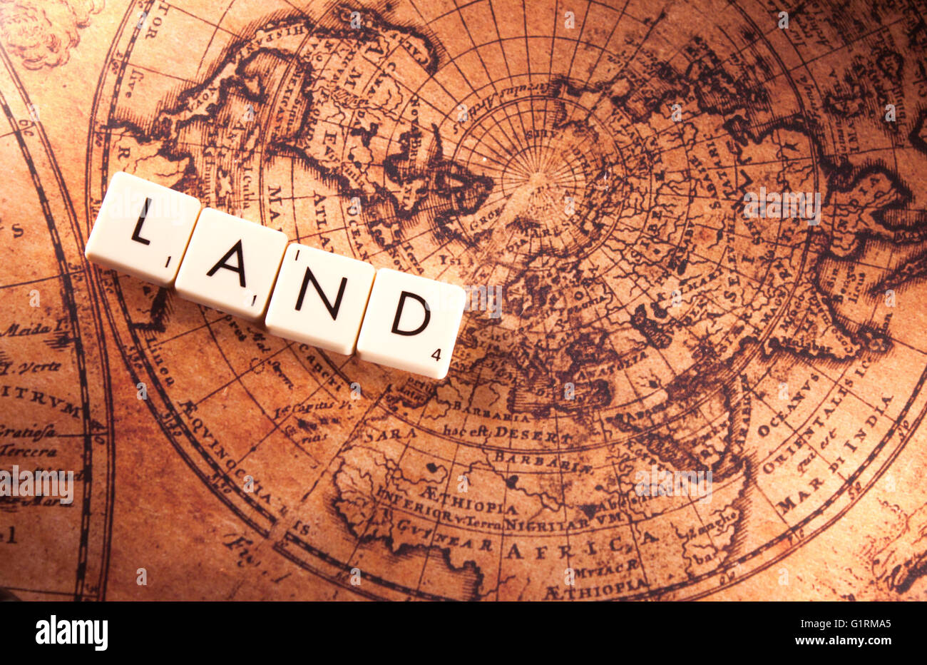The text land on a brown world map Stock Photo