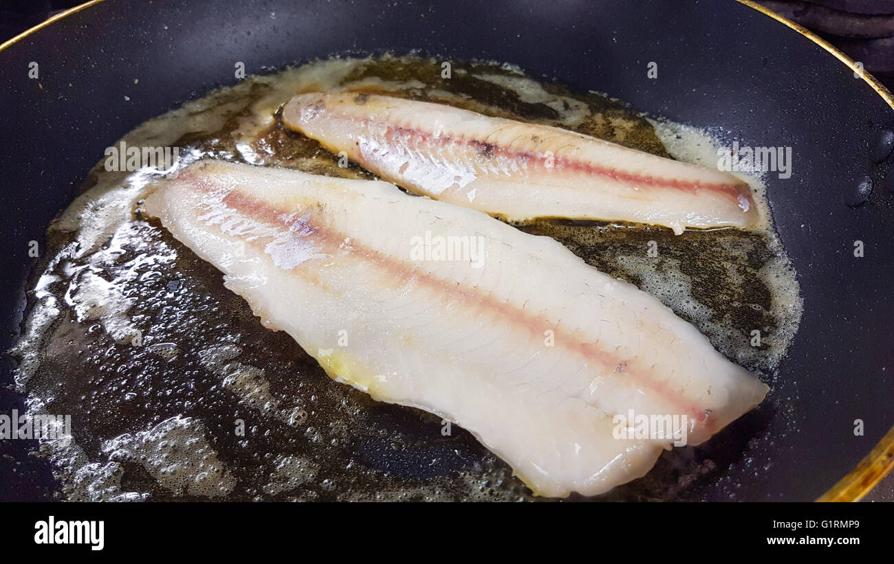 Frying zander or pike-perch fillets, on a frying pan Stock Photo