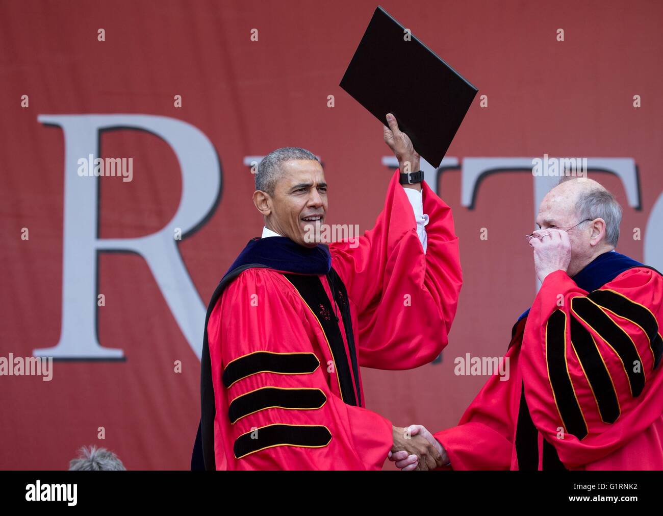 U.S President Barack Obama holds up his diploma after receiving an honorary degree following his commencement address at Rutgers University May 15, 2016 in New Brunswick, New Jersey. Stock Photo