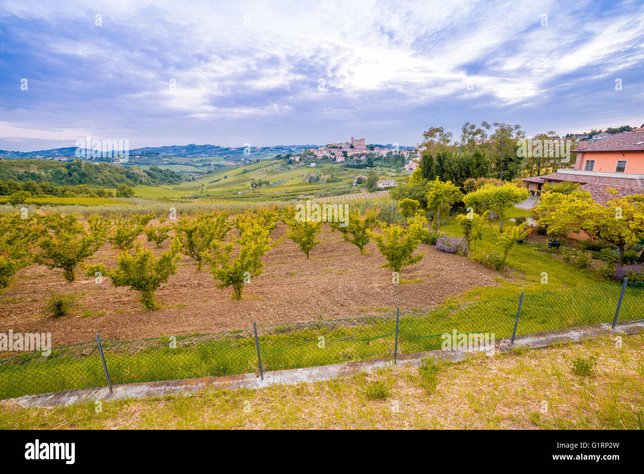 panorama of cultivated fields on the hills of Emilia Romagna dominated by Malatestian Castle, medieval fortress dating back to 1200 AD, of Longiano, Italy Stock Photo