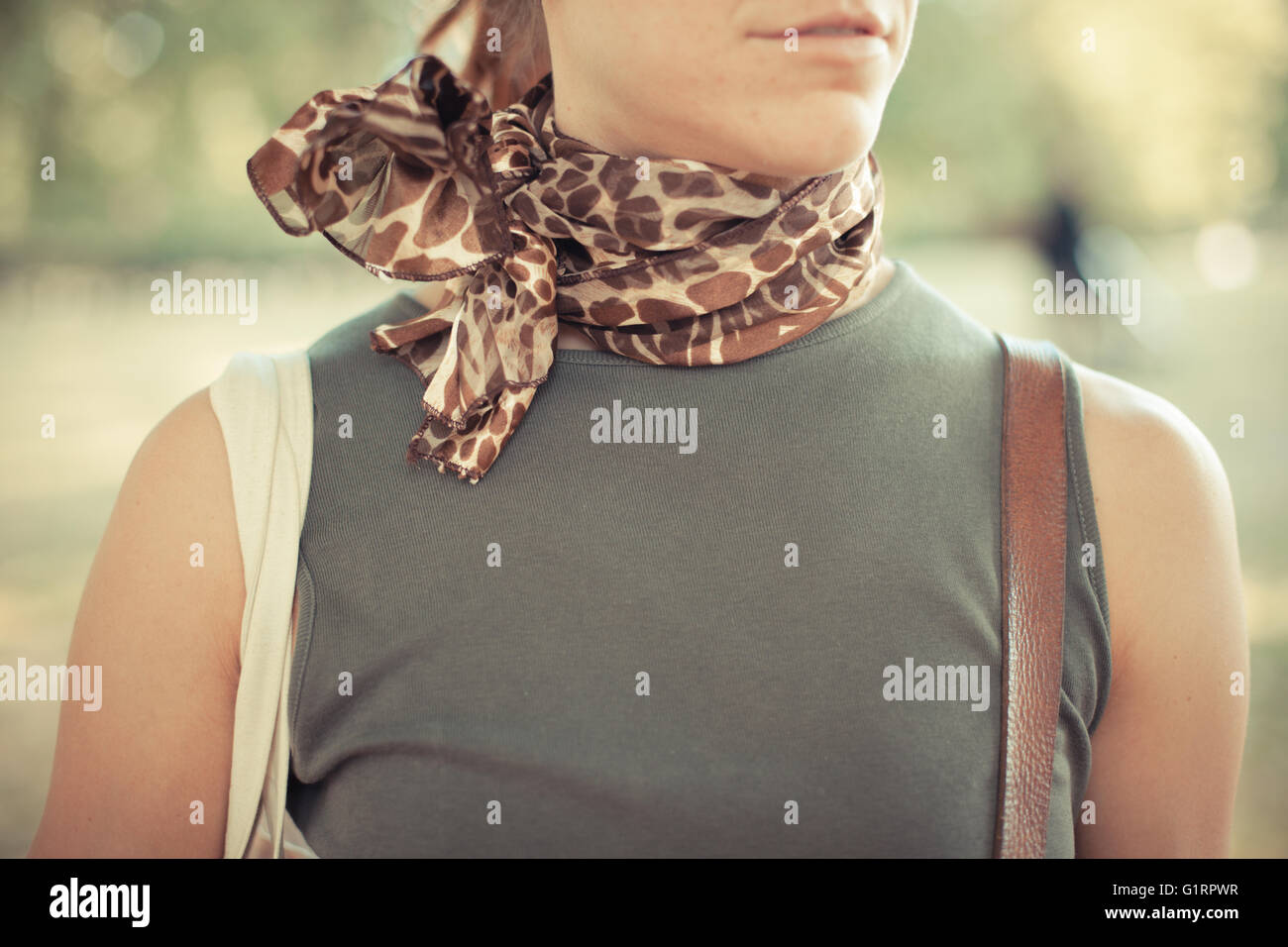A young woman is standing in the park at sunset Stock Photo - Alamy