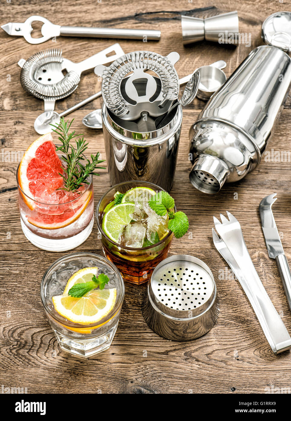 Cocktails with fruits and ice. Cold lemonade, mojito, caipirinha. Bar drink making tools Stock Photo