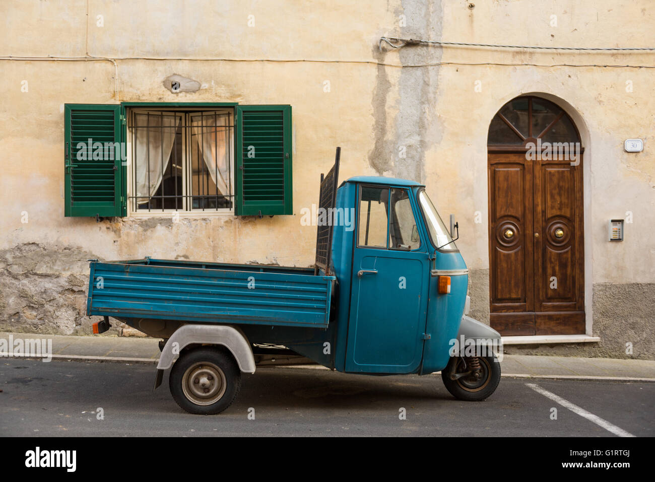 Typical Italian Tricycle Piaggio Ape parked in an alley, Pitigliano, Maremma, district Grosseto, Tuscany, Italy Stock Photo