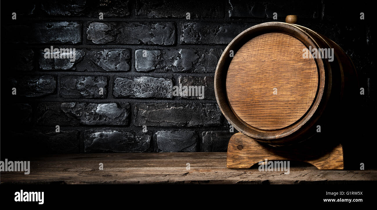 Wooden cask and wall made of bricks Stock Photo