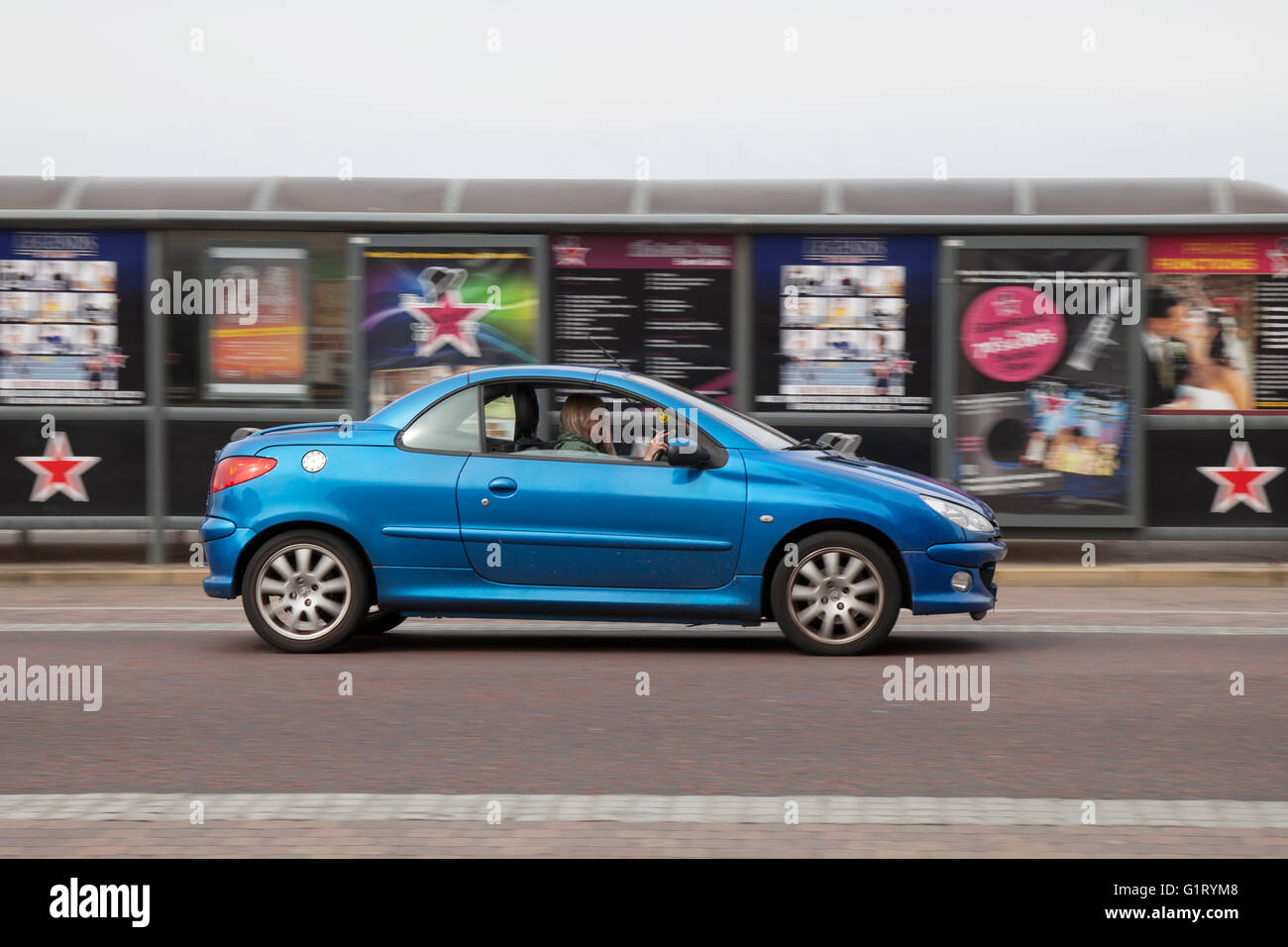 Peugeot 206 cc vehicle in motion being driven along the seafront at Blackpool, Lancashire, UK. Stock Photo