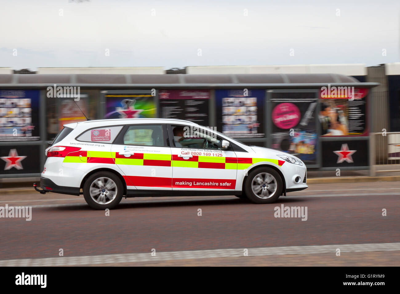 Community Fire Service side view VW Volkswagen vehicle in motion being driven along the seafront at Blackpool, Lancashire, UK. Stock Photo