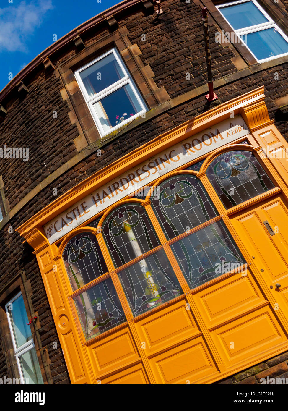 Traditional hairdressing salon on curved building in Carlisle city centre Cumbria England UK Stock Photo