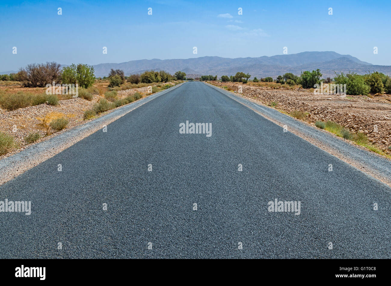 Automobile road in desert with blue sky Stock Photo - Alamy