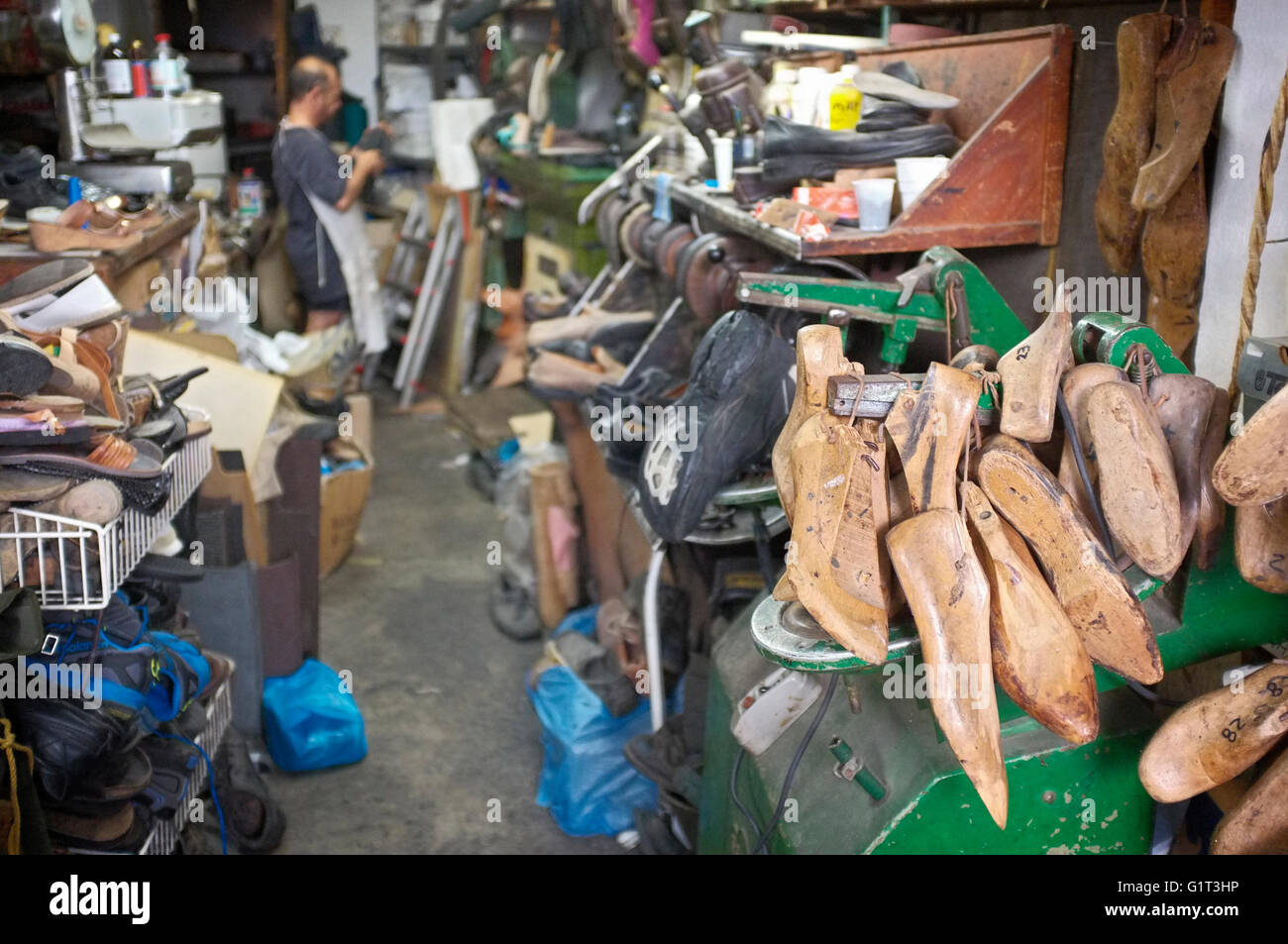 a cobbler / shoe mender works in his in naxos, the cyclades