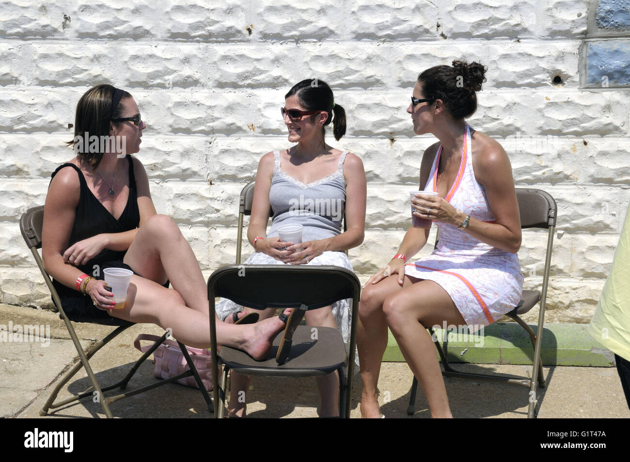 3 women talking at a back yard party in Annapolis, Maryland Stock Photo