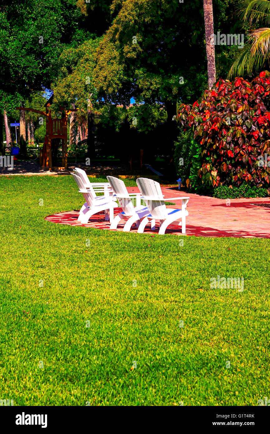 Plastic chairs in the gardens at the Gasparilla Inn & Club, Boca Grande, on Gasparilla Island, Florida Stock Photo
