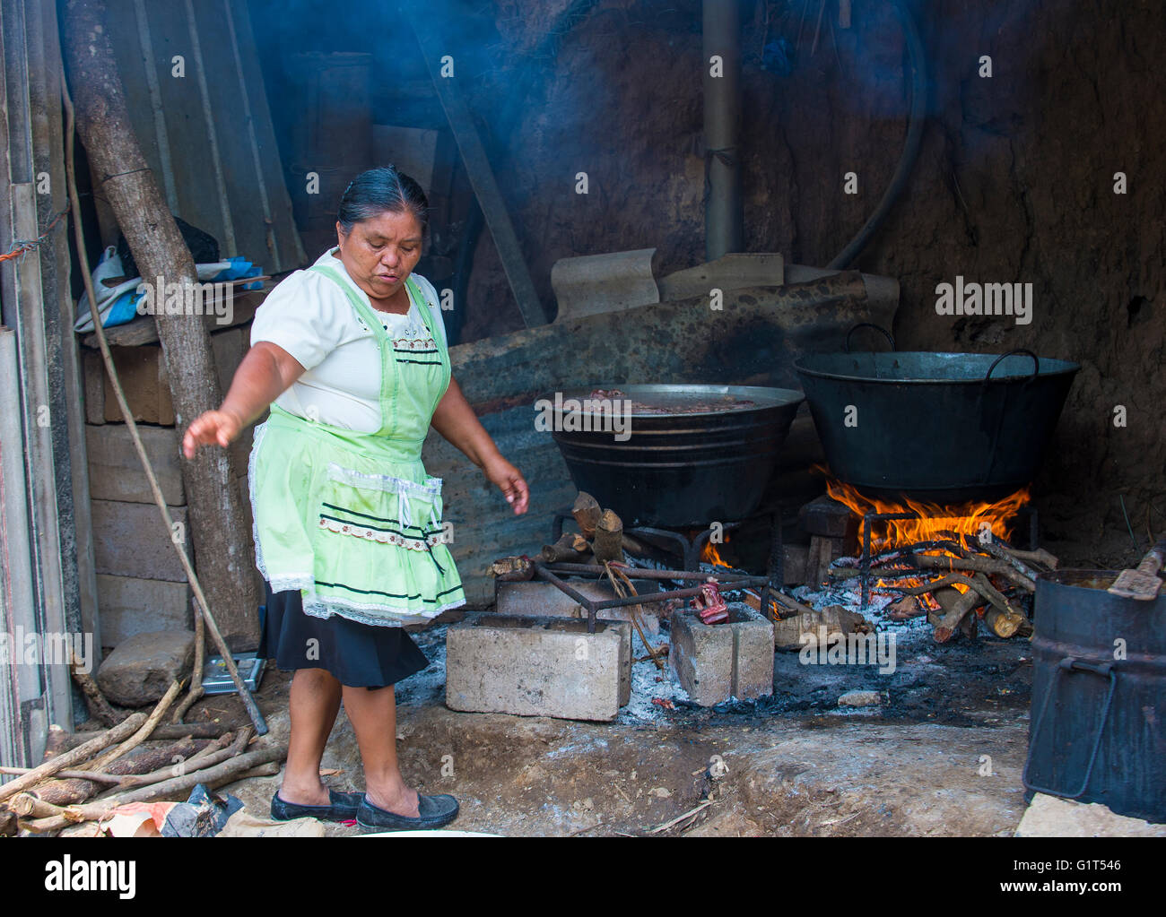 A Salvadoran woman cooks during the Flower & Palm Festival in Panchimalco, El Salvador Stock Photo