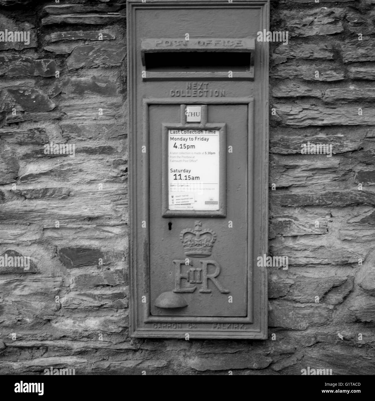 Old fashioned post box set into a stone wall Stock Photo