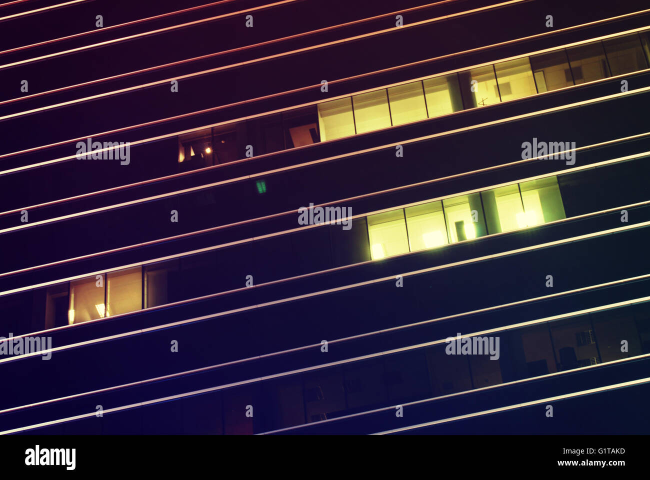 Abstract closeup detail of building architecture at night with geometric lines. Stock Photo