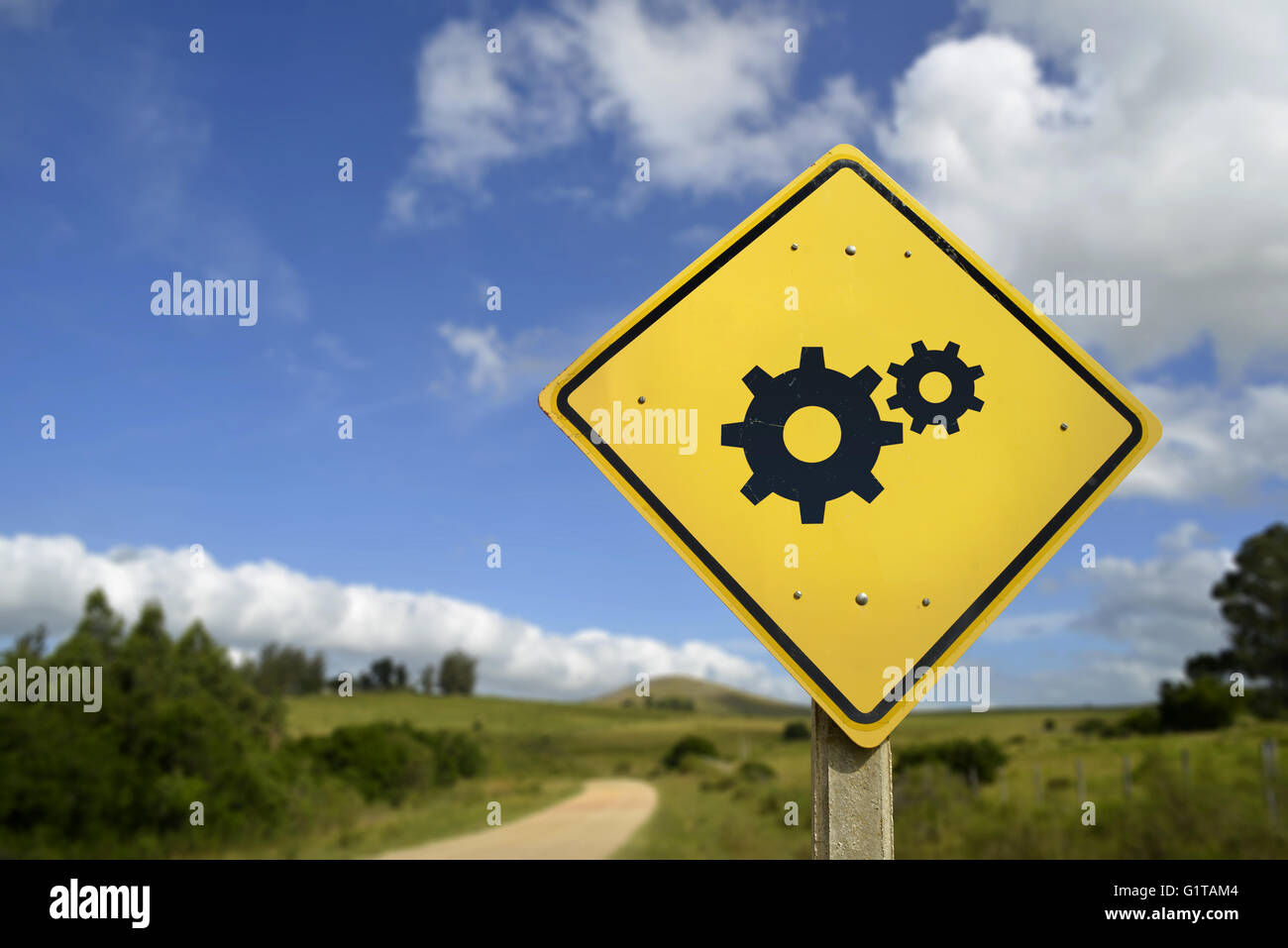 Access to technical support everywhere concept. Road sign with gear wheel icon on nature environment, includes copy space. Stock Photo